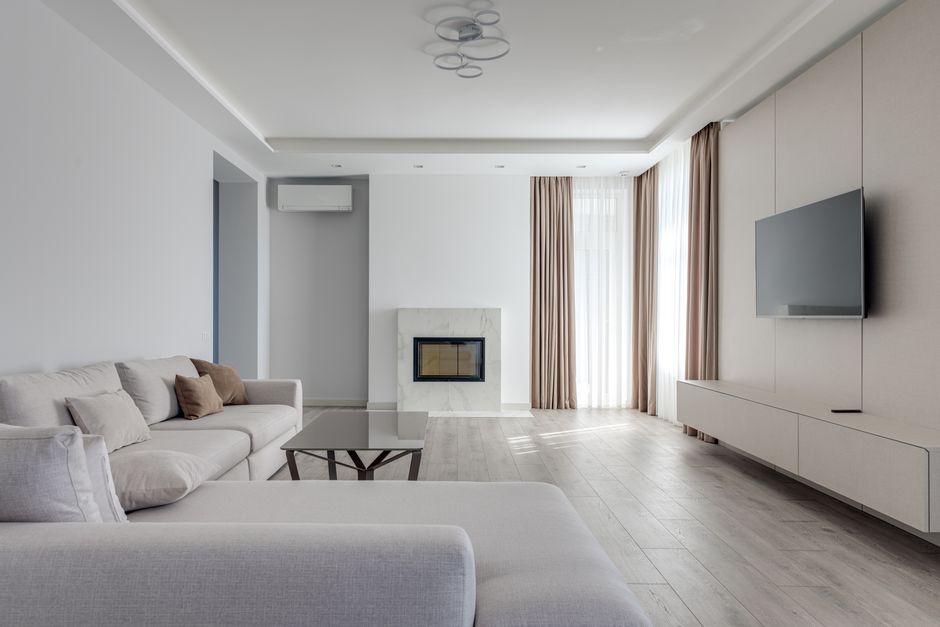 A freshly cleaned and tidied minimalist living room with plush cushions and a simple coffee table, ready for relaxation.