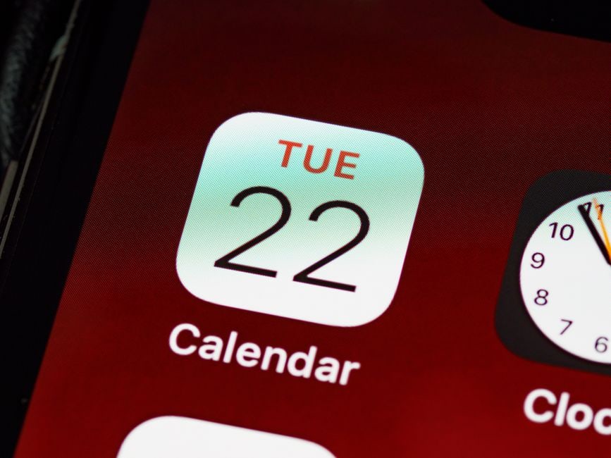 A close-up view of a vibrant digital calendar displaying color-coded entries for different family members and event types, illustrating an organized schedule.