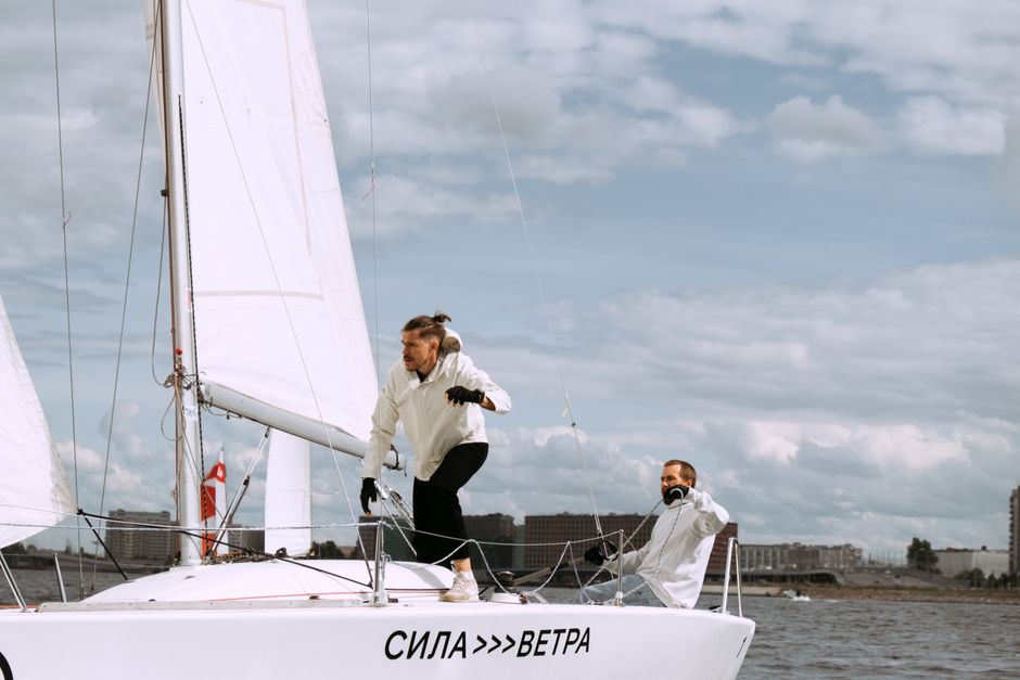 A colorful, hand-drawn indie game scene showing a small boat sailing across calm waters towards a whimsical island, highlighting peaceful exploration.