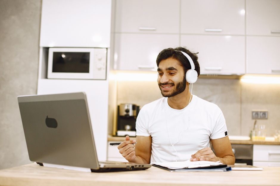 A split image showing three remote workers, each wearing different types of headphones and engaged in video calls from various locations, including a home office and a co-working space.