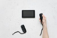 A family, including two parents and two children, laughing and playing a brightly colored video game on a Nintendo Switch console, with French dialogue subtly visible on the screen.