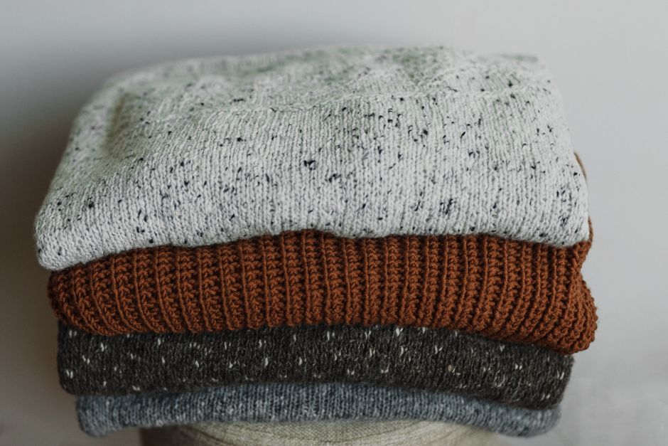 A neatly organized wardrobe drawer with folded cashmere sweaters of various colors, showcasing proper storage to keep delicate clothing wearable longer.