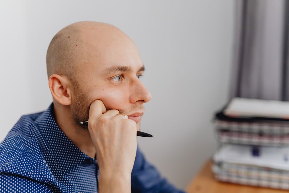 A person sitting at a desk, deep in thought, with multiple sticky notes representing different opportunities and decisions.