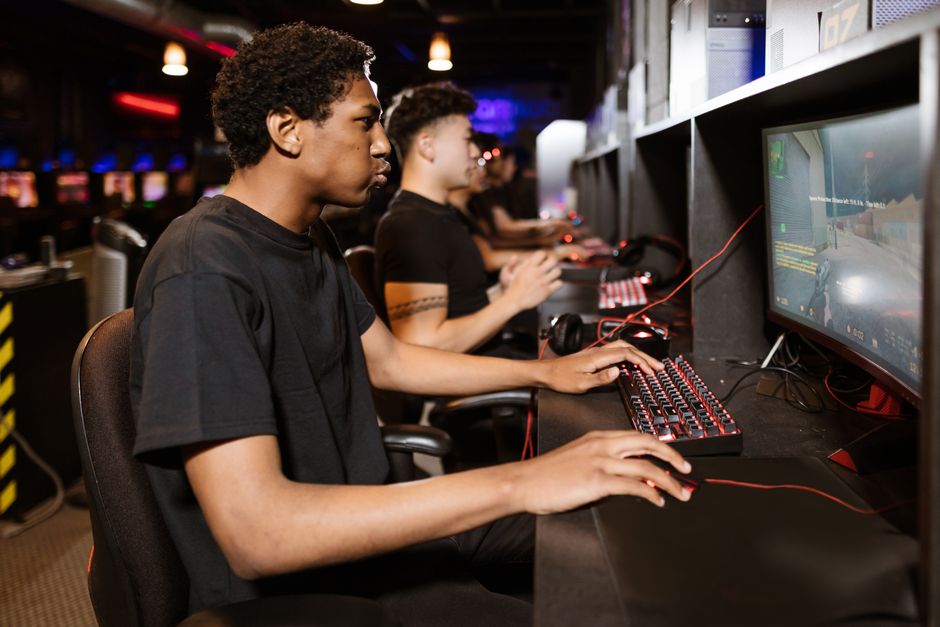 A gamer intently reading online reviews and forums on a computer screen, researching narrative-rich indie titles.