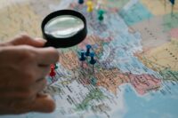 Digital map showing multiple location pins across continents, symbolizing global reach from a local point.