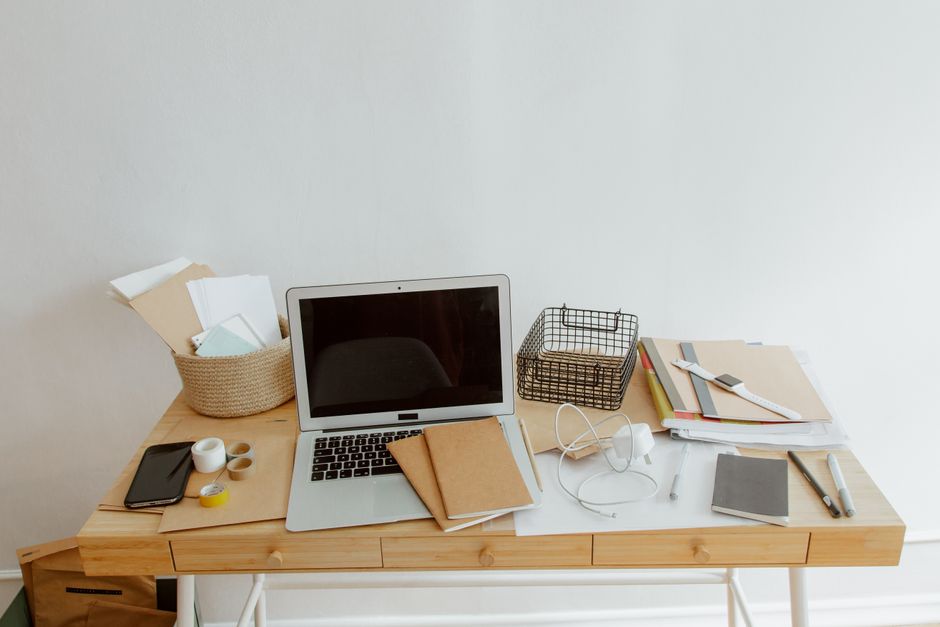 Split image showing a cluttered desk on one side and an organized, minimalist desk on the other, representing a digital declutter.