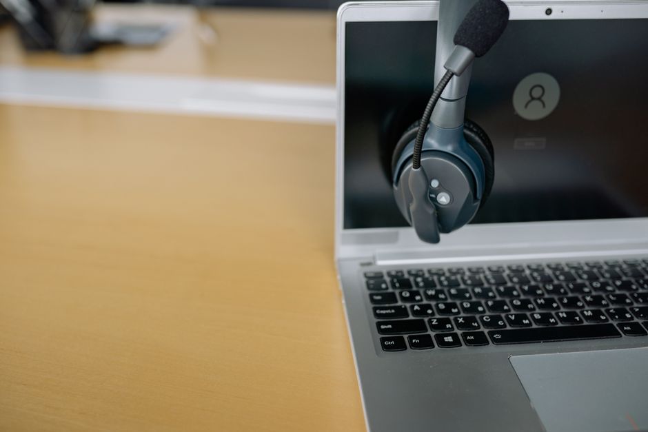 A close-up of a person wearing a professional-grade headset with a boom microphone, ensuring clear audio during a virtual meeting.