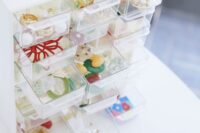 A neatly organized jewelry box displaying a curated collection of minimalist gold and silver earrings, rings, and necklaces, reflecting a versatile and streamlined aesthetic.