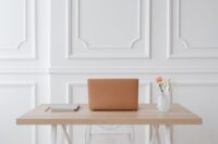 A clean, minimalist desk setup with a silent mechanical keyboard, a quiet mouse, and a fanless mini PC, emphasizing a calm work environment.