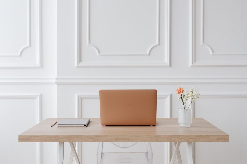 A clean, minimalist desk setup with a silent mechanical keyboard, a quiet mouse, and a fanless mini PC, emphasizing a calm work environment.