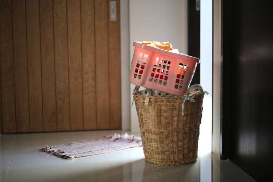 A neatly organized laundry room with baskets of clean towels and folded sheets, ready for storage or use.