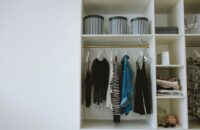 A neatly organized closet with clothes categorized by color and type, representing an efficient wardrobe.