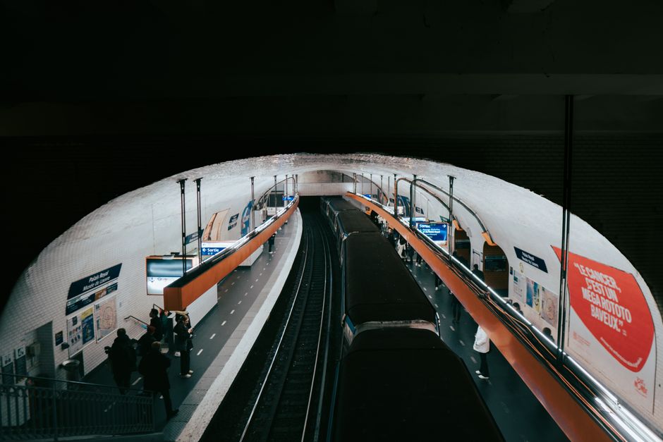 A clean, well-lit platform in a Paris Métro station, illustrating efficient urban transit for accessing cultural sites.