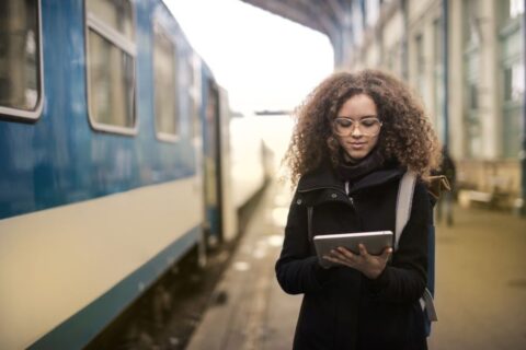 A person holding a tablet showing an e-book, comfortable reading during travel.