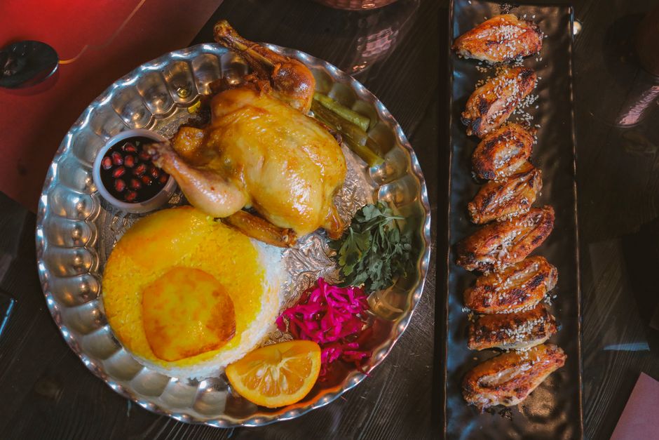 A perfectly roasted golden-brown chicken on a platter, surrounded by roasted potatoes and green beans, ready to be carved for a family dinner.