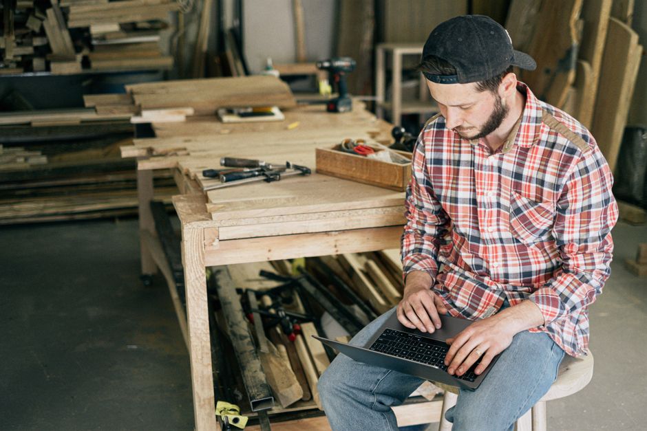A small business owner happily working on a laptop, surrounded by illustrative icons representing AI tools and automation, emphasizing ease of use for non-developers.