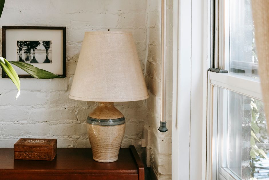 A cozy apartment living room with a floor lamp plugged into a smart plug, illustrating easy smart home integration for renters.
