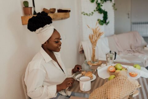 A person enjoying a healthy breakfast of oatmeal with berries and nuts at a hotel, preparing for a long day of sightseeing.