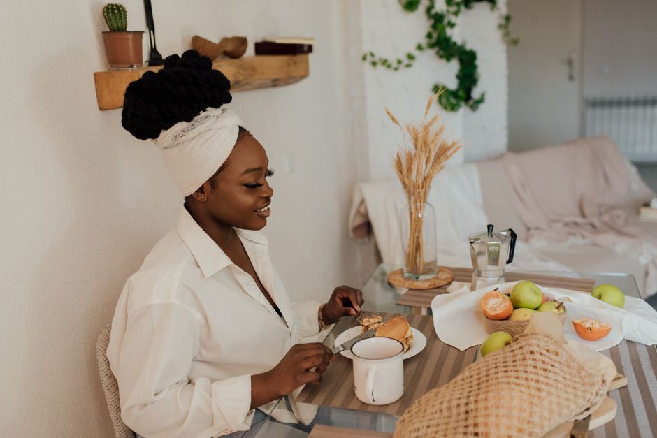 A person enjoying a healthy breakfast of oatmeal with berries and nuts at a hotel, preparing for a long day of sightseeing.